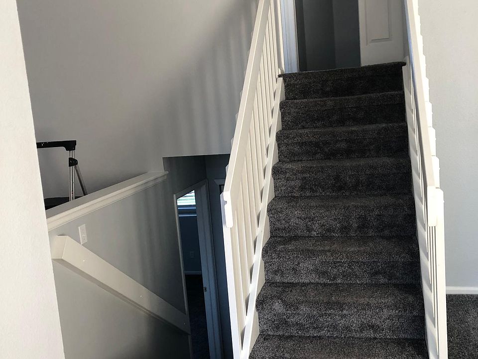 Photo taken from front entry to the stairway heading up to 2nd floor - laundry at top of stairs to the right in the closet. Master Bedroom at top of stairs to the left.