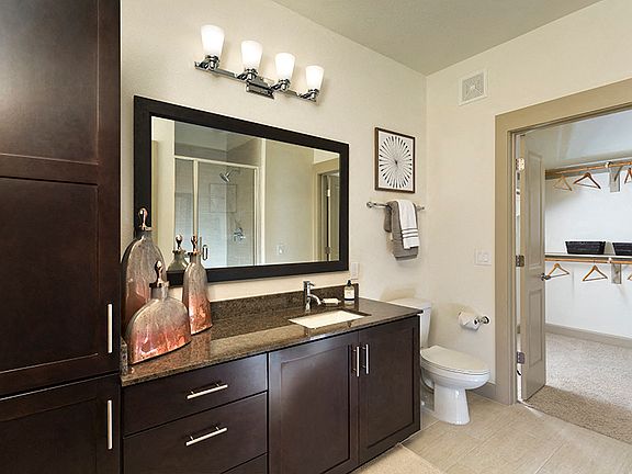Walk-in showers with glass doors and ceramic tile surround