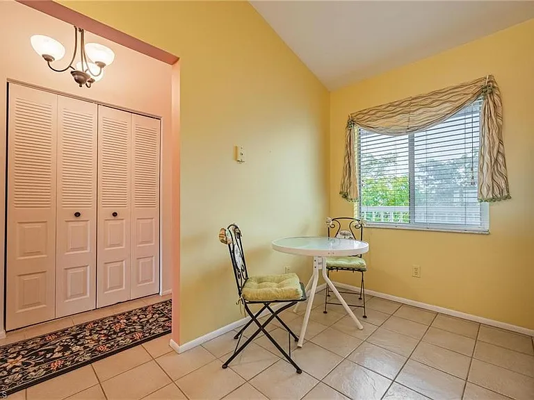 Kitchen table for 2. Kitchen and front hallway repainted bright white.