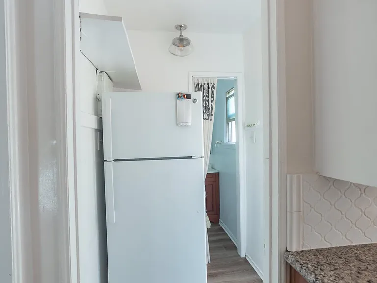 Back entry connects kitchen & 1/2 bathroom
