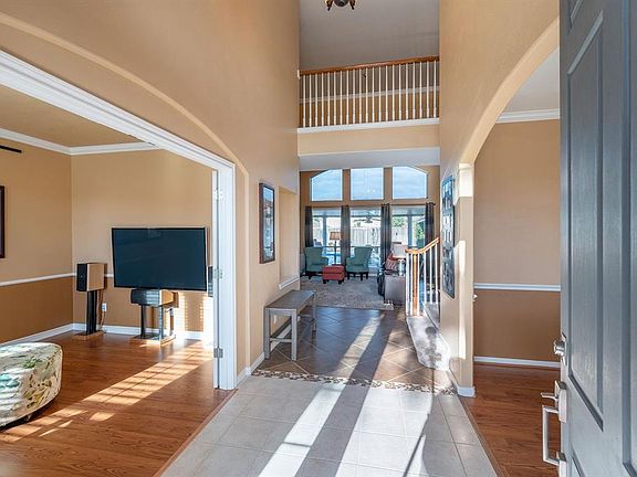 Lovely 2 story light filled entry to welcome you home. Features crown molding from office and formal dining.