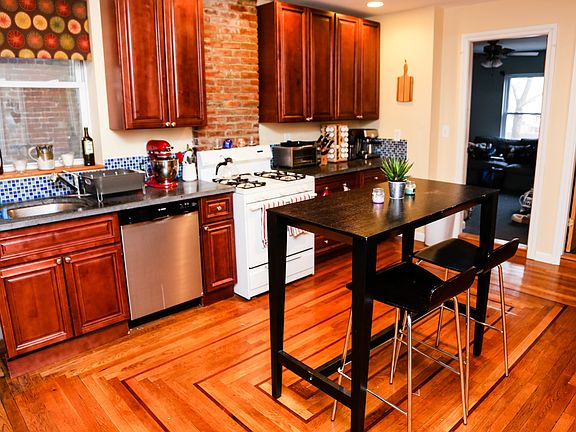Updated kitchen with hardwood floors and concrete countertop