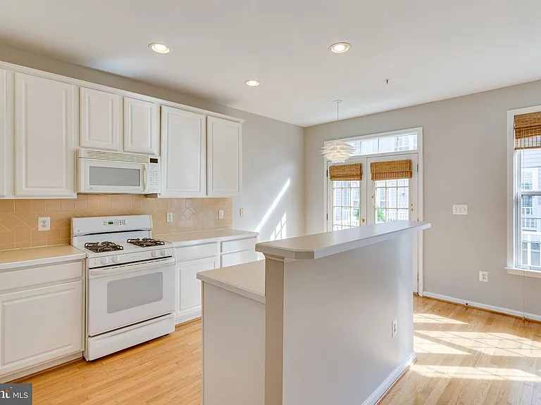 Light and Bright Kitchen great room, with big windows, & includes a cozy family room with fireplace on opposite wall.