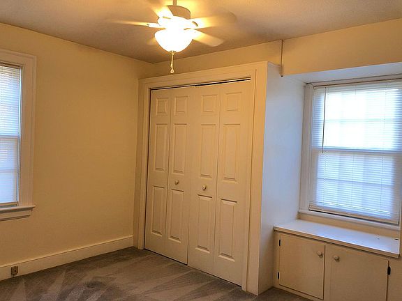 bedroom with built in window seat and cabinets