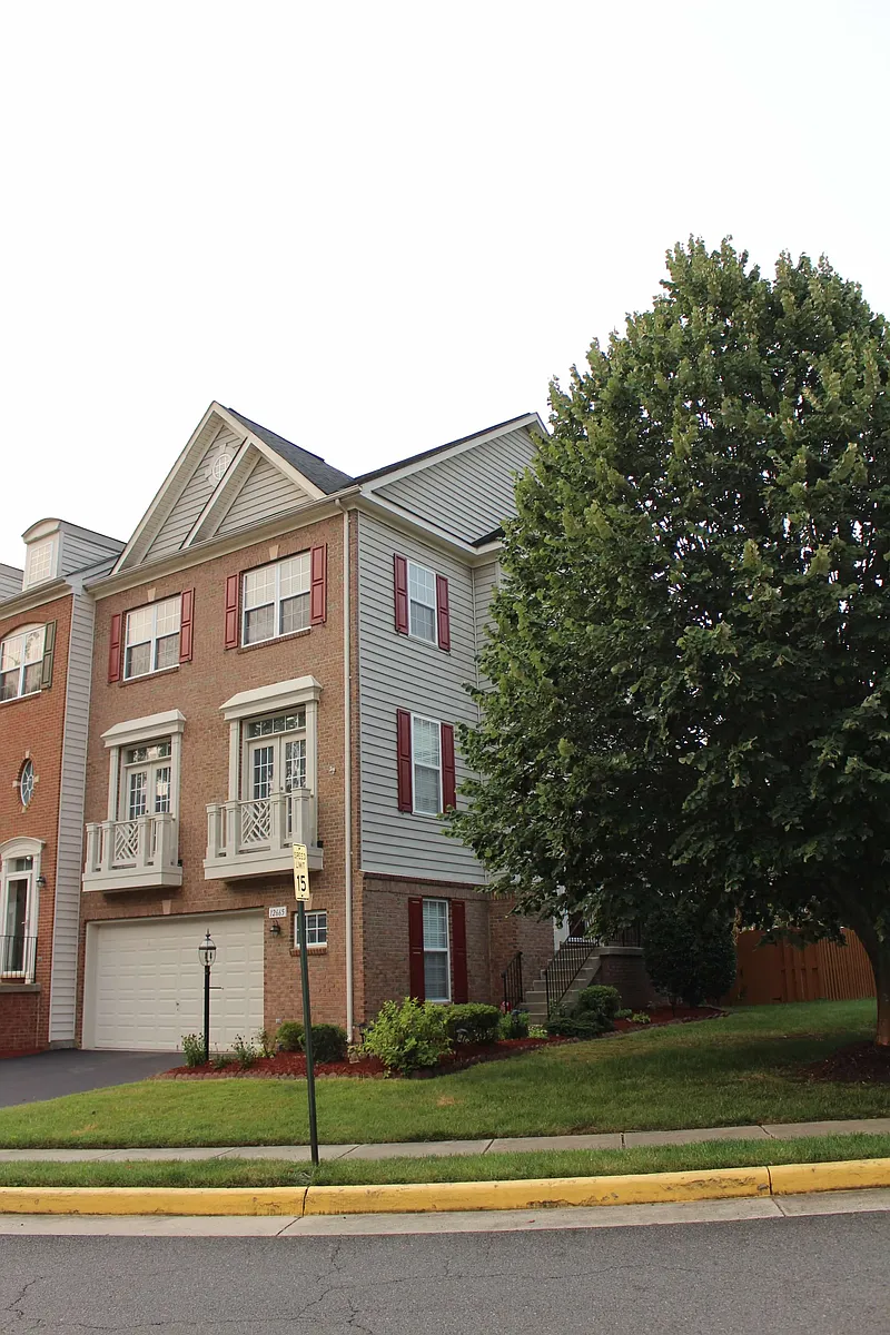 Front and side view of end unit townhome with lush garden and easy access to walking paths and extra parking - 12665 Heron Ridge Dr