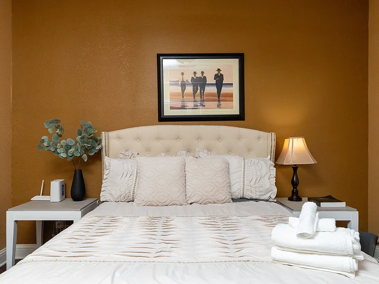 Cozy and inviting bedroom featuring a tufted headboard and warm, earthy tones.