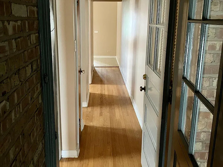 Rear door leading to long interior hallway