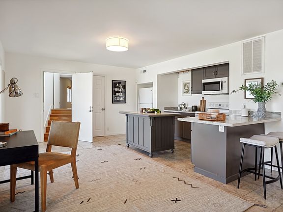 Downstairs kitchen with dining room and sliding door to outside covered deck with bay views