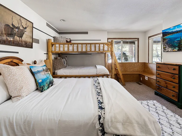 Downstairs large guest room with private bathroom/shower. Thick Pine Bunk with 2 twin beds and stand alone Queen bed w/ Smart TV