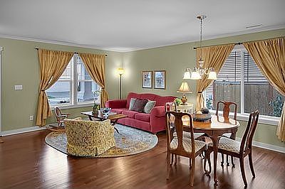 Features include plantation blinds, crown molding and wood wrapped windows