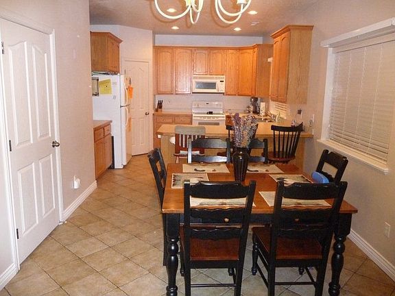 Kitchen and dining rooms.  The kitchen includes a refrigerator.