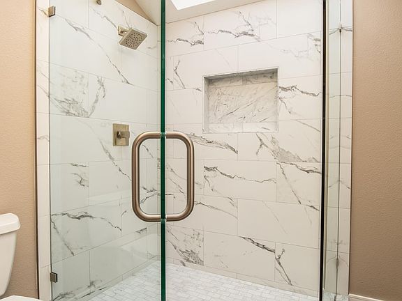 Carrera Master Marble shower with frameless glass enclosure