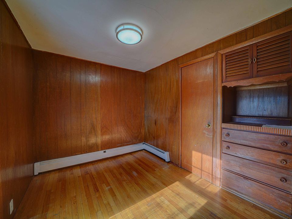 Smaller Bedroom in back of home can be a den or office has a closet and built in bureau
