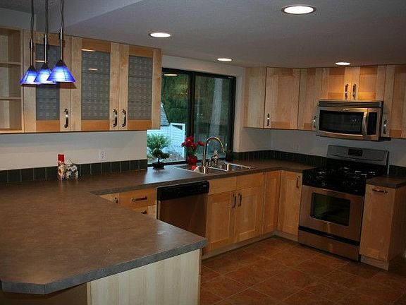 Lovely remodeled kitchen with tile accents and new cabinetry
