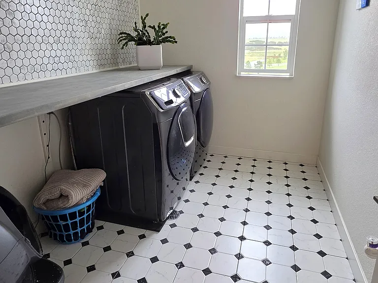 Laundry room upstairs between the bedrooms