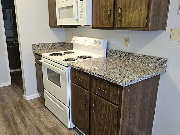 Kitchen - gas stove, microwave and granite countertops
