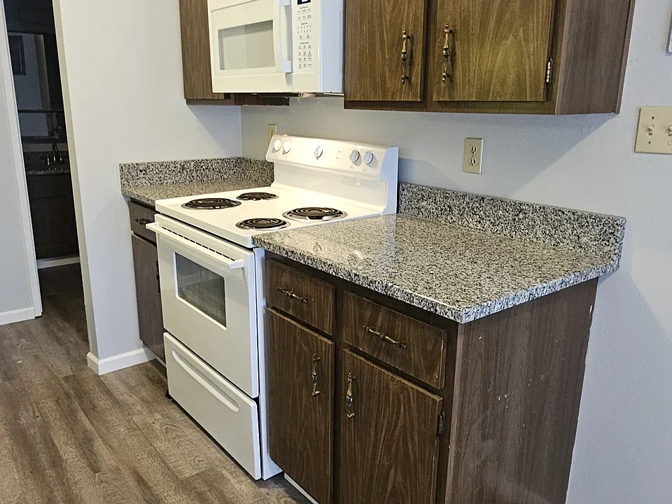 Kitchen - gas stove, microwave and granite countertops