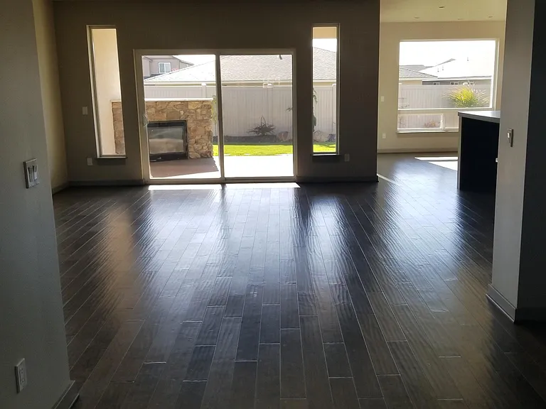 View of Great Room from the front door hallway. Large living room/great room with fireplace.