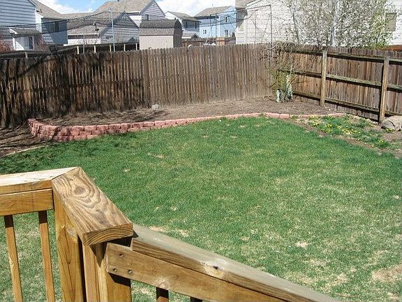 Big fully fenced backyard has room for playing catch, gardening, or both