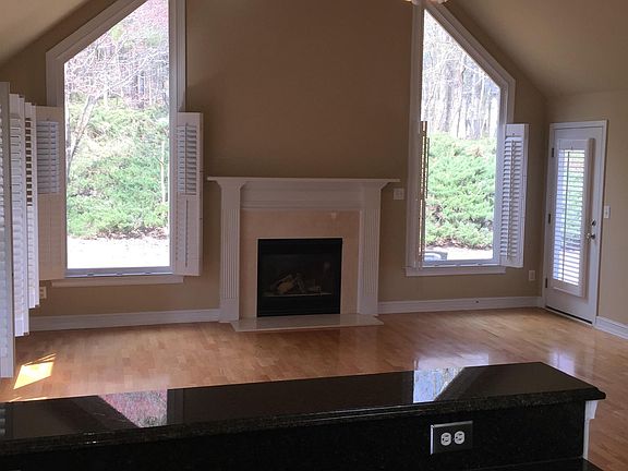 Kitchen view of keeping room, gas fireplace with logs and garden view