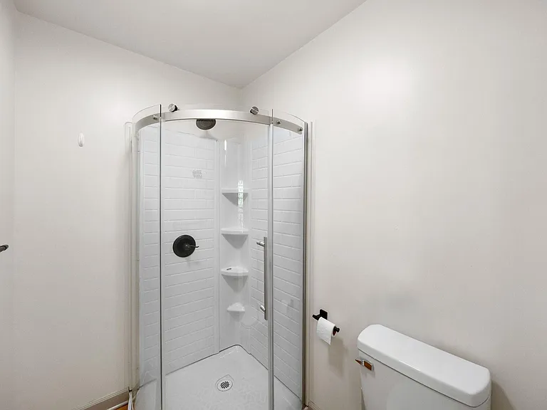 Ensuite bathroom with built-in shelving and a clean, simple layout for easy daily use.