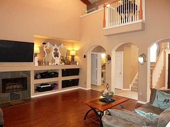 Living room has gas log fireplace and built-ins