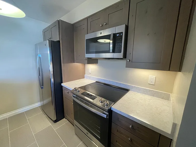 Kitchen with brand new refrigerator, stove and microwave