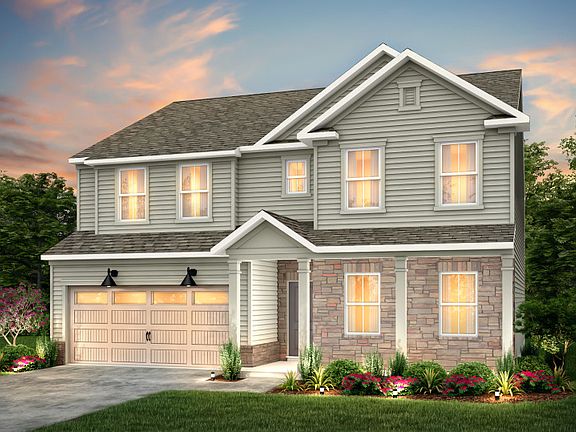 Mitchell Exterior LC2P features siding, stone, covered front siting porch and 2 car garage