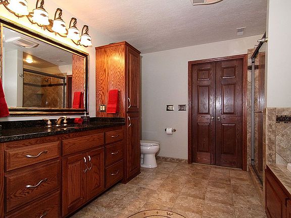 Master bath with gorgeous tile work, double vanity & cabinets w/walk-in closet
