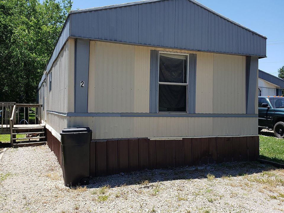 Front showing front deck and parking area.