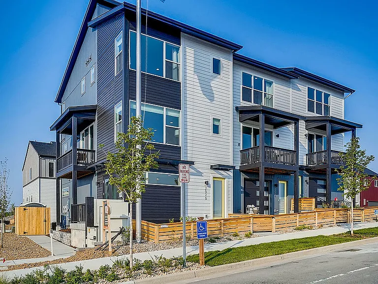 Explore this contemporary townhouse, featuring expansive windows and charming balconies.