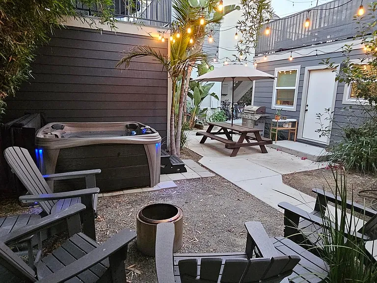courtyard with jacuzzi tub and fire pit social area now