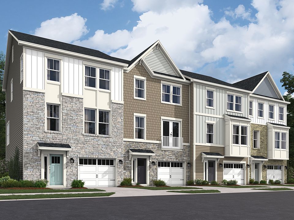 Front elevation of a 3 level townhomes with stone, and siding