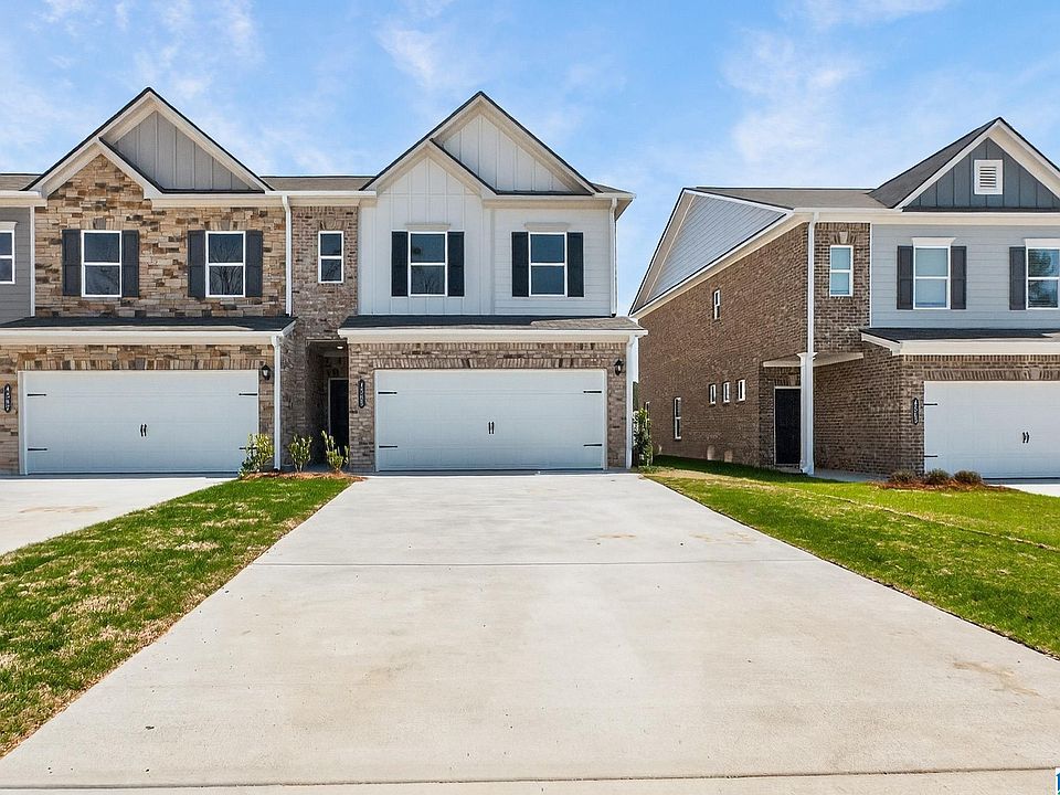 Craftsman-style home with board and batten siding, a garage, driveway, and a front yard