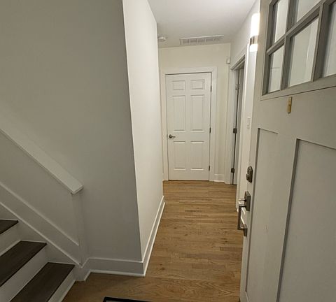 The hallway just inside the front door takes you to two bedrooms, a full bath, a laundry center, and storage closets