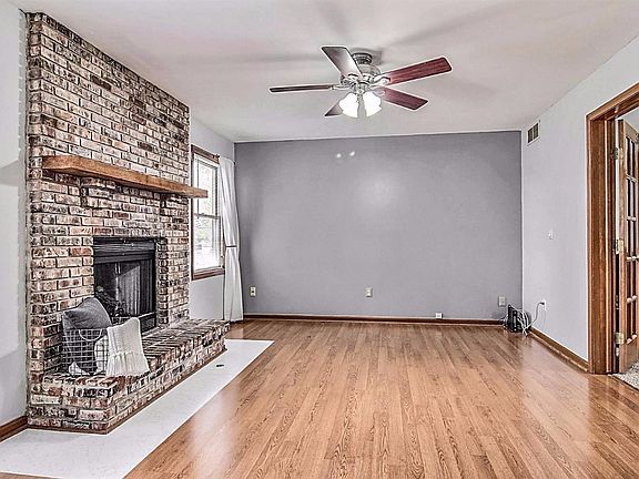 FAMILY ROOM OFF THE KITCHEN FEATURES FIREPLACE AND FRENCH DOORS TO THE LIVING ROOM