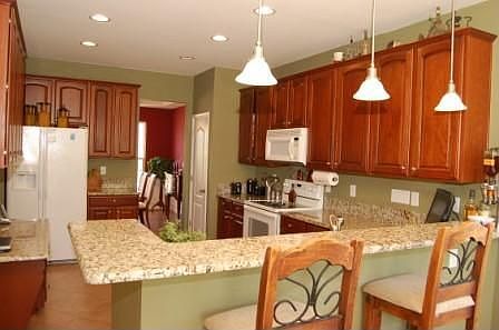 Kitchen has granite countertops and cherry cabinets