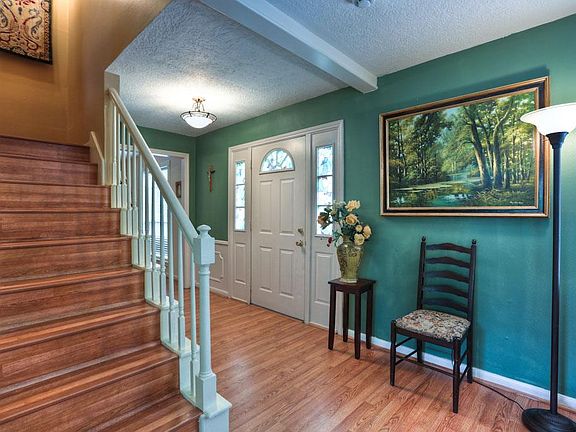 Architectural details are abundant and include fluted window casings with rosettes.