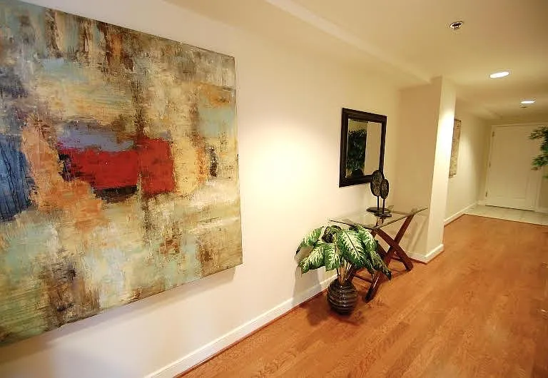 Entry Hallway with Contemporary Artwork and Hardwood Floors