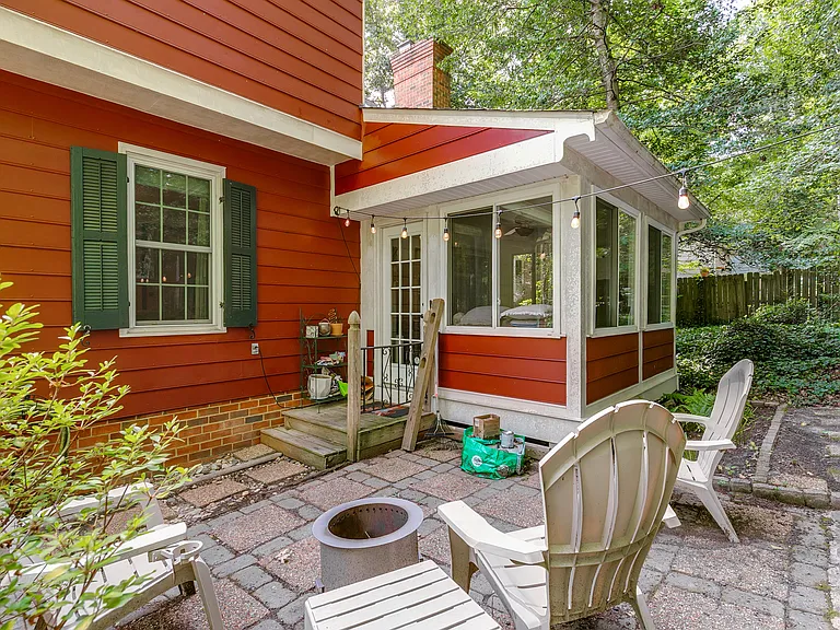 Stone patio surrounded be lush landscaping. Lawn care provided within the rent!