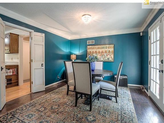 SUNFILLED DINNING ROOM OFF KITCHEN AND GREAT ROOM. FRENCH DOORS TO THE DECK AND PATIO.
