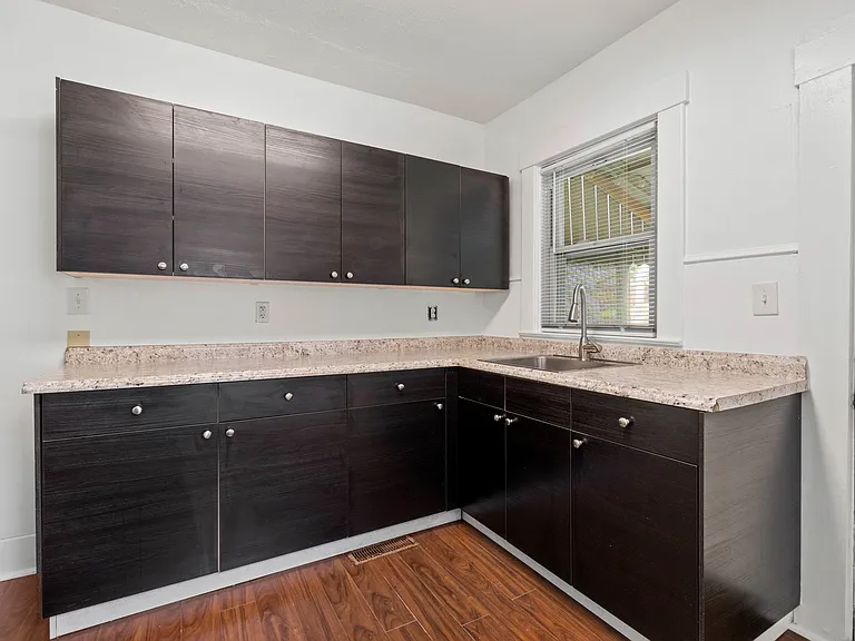 Great cabinet space! Window over the sink looking out to the back porch and yard.