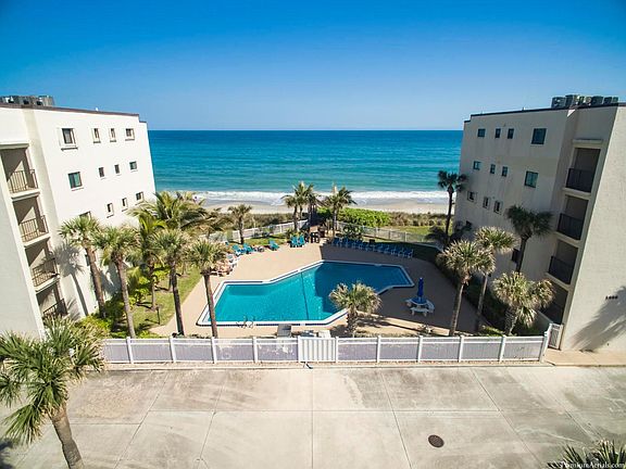 Large resort style pool with beach view