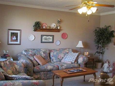The living room is spacious and has an open pass thru to the kitchen.