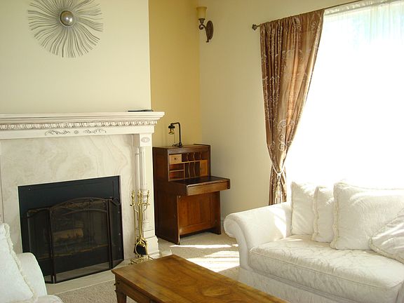 Formal sunken living room with wood burning fireplace