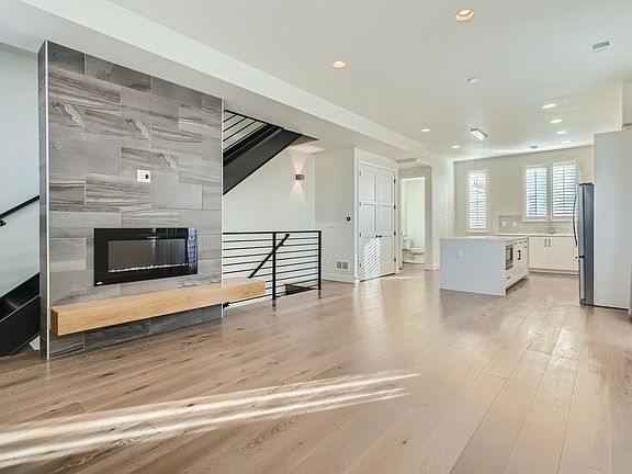 Bright, open concept living room, dining, kitchen, and powder room