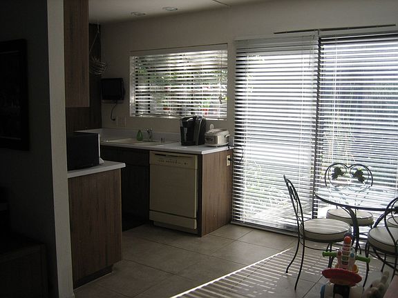 View into kitchen, dining and private patio