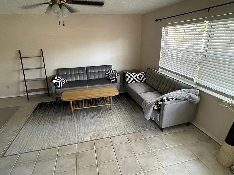 Spacious very well lit living room. Sofas not available.
