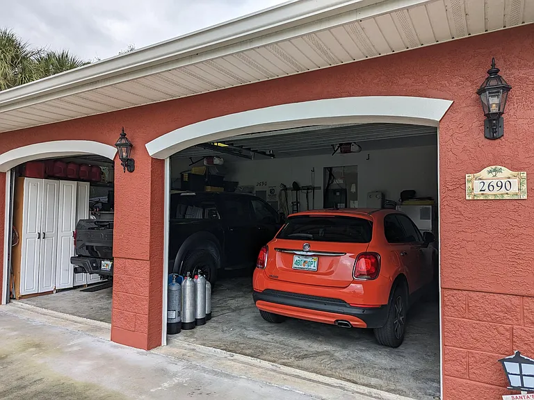 Built-in storage units and workbench adorn the left side of the garage.