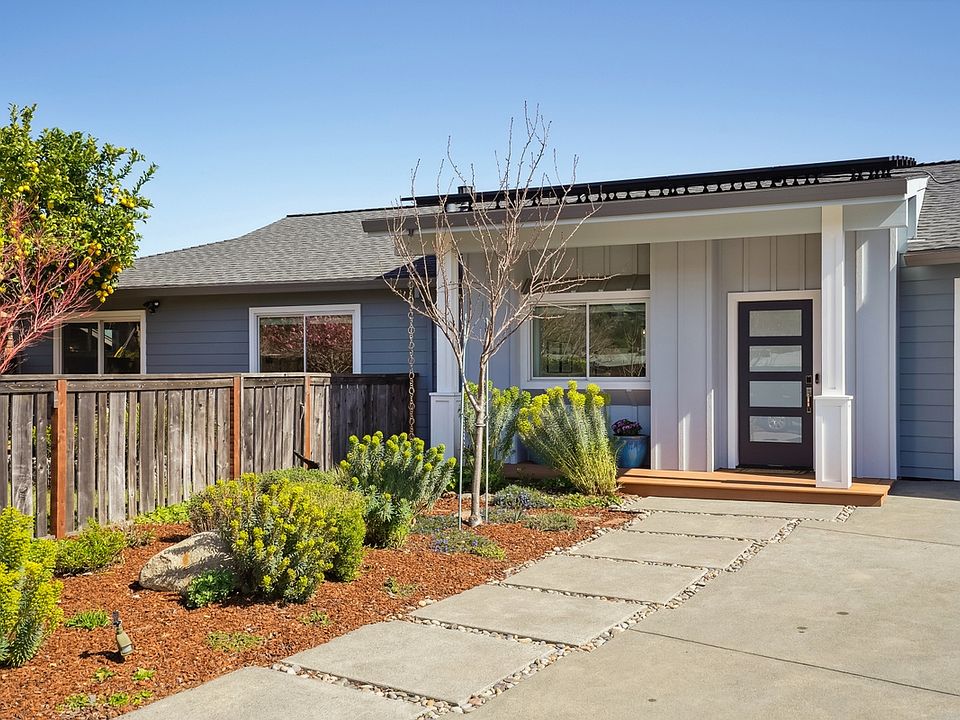 Front of house, driveway and 2 car garage with EV charging